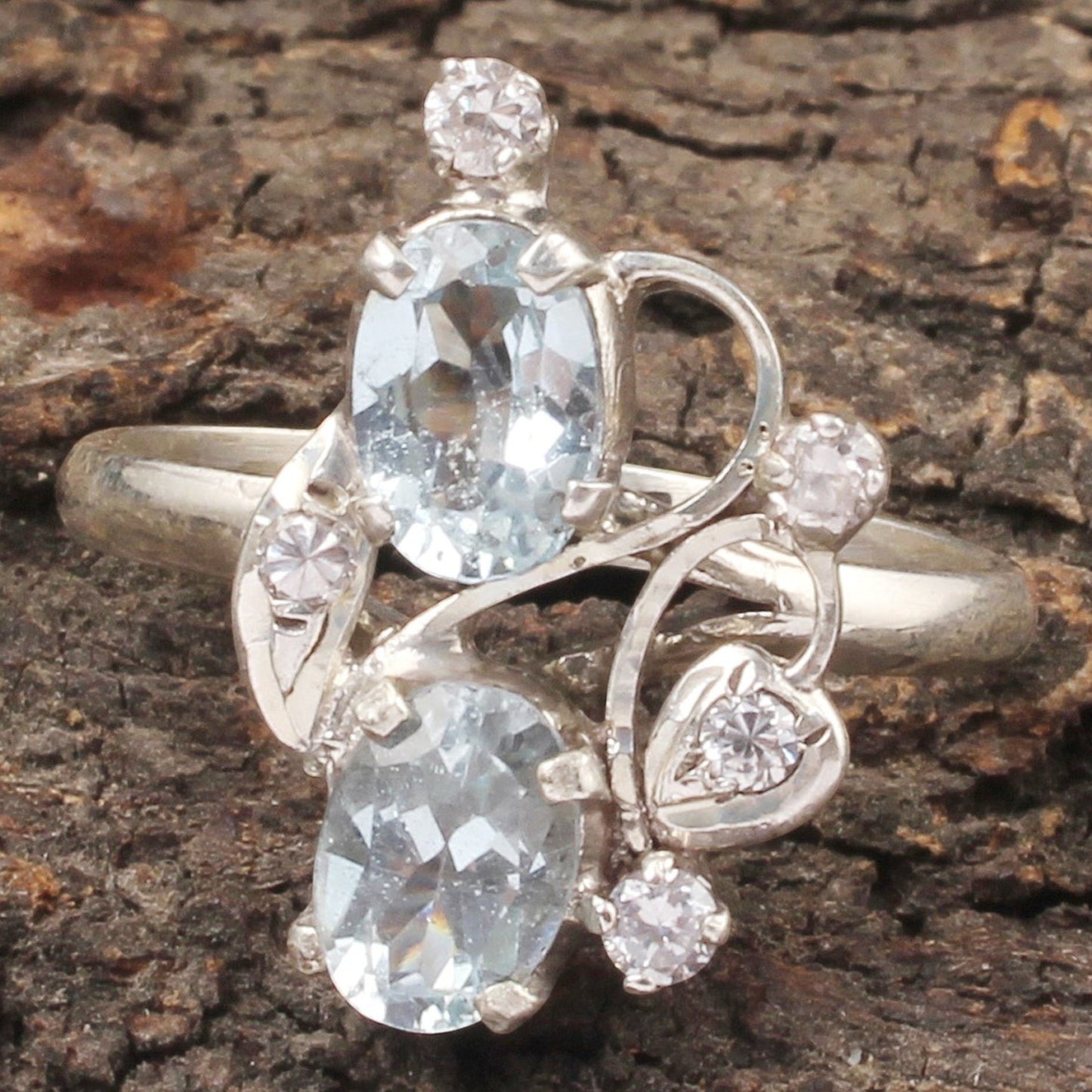 Jewels and art Emporium india sterling silver ring with two oval blue topaz stones and cubic zirconia accents in a prong setting.