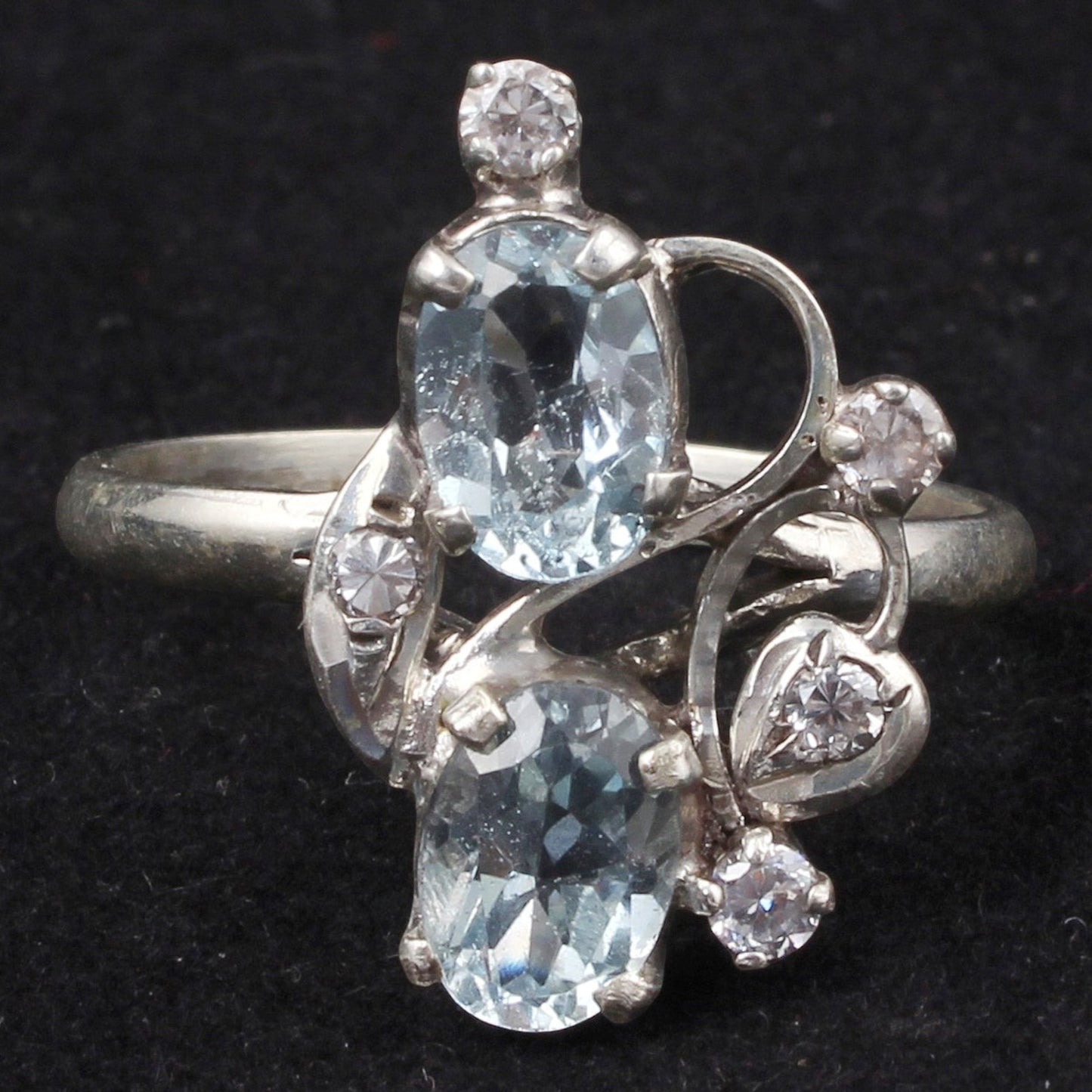 Jewels and art Emporium india sterling silver ring with two oval blue topaz stones and small cubic zirconia accents in a prong setting.
