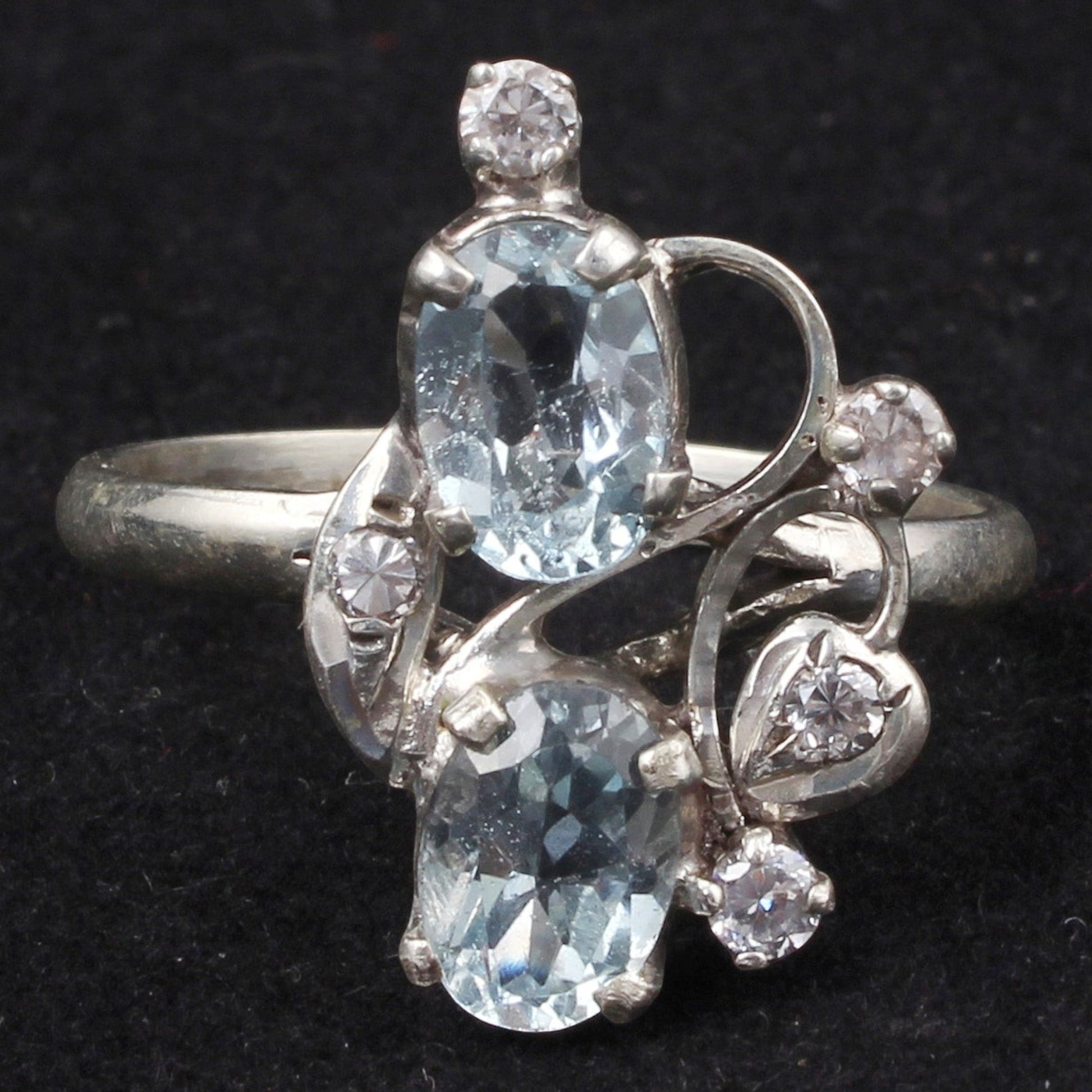 Jewels and art Emporium india sterling silver ring with two oval blue topaz stones and small cubic zirconia accents in a prong setting.