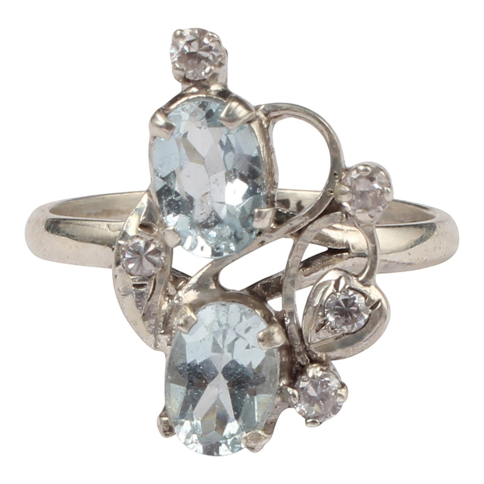 Jewels and art Emporium india silver ring with two oval blue topaz stones and small clear cubic zirconia accents in a floral design.