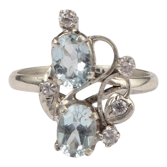 Jewels and art Emporium india silver ring with two oval blue topaz stones and small clear cubic zirconia accents in a floral design.